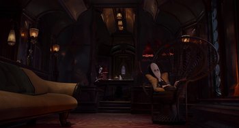 Movie still from “The Addams Family 2” (2021), directed by Greg Tiernan – A person sitting in a chair in a dark room; Wide shot, High angle