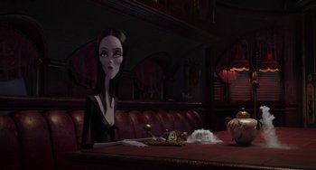 Movie still from “The Addams Family 2” (2021), directed by Greg Tiernan – A woman sitting at a table in front of a cat; Medium shot, Over the shoulder angle