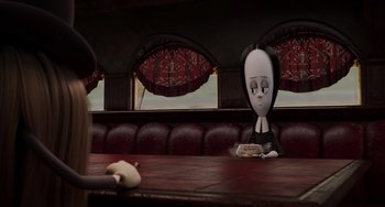 Movie still from “The Addams Family 2” (2021), directed by Greg Tiernan – A cartoon character sitting at a table in a restaurant; Medium shot, High angle