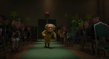 Movie still from “The Addams Family 2” (2021), directed by Greg Tiernan – A man in a yellow suit is walking down a runway; Wide shot, Low angle