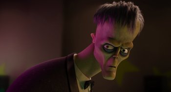 Movie still from “The Addams Family 2” (2021), directed by Greg Tiernan – A man in a suit and tie with a strange face; Close Up shot, Over the shoulder angle