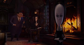 Movie still from “The Addams Family 2” (2021), directed by Greg Tiernan – The addams family is sitting in a room with a fireplace; Wide shot, High angle
