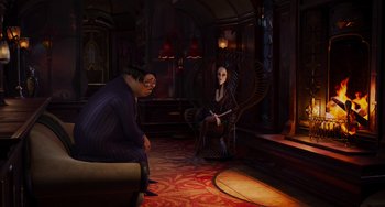 Movie still from “The Addams Family 2” (2021), directed by Greg Tiernan – A man and a woman sitting on a chair in a living room; Wide shot, High angle