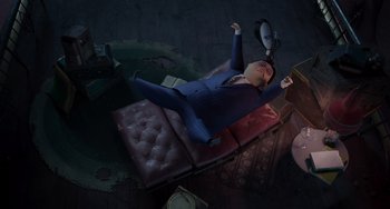 Movie still from “The Addams Family 2” (2021), directed by Greg Tiernan – An image of a man laying on a couch in the dark; Wide shot, Overhead angle