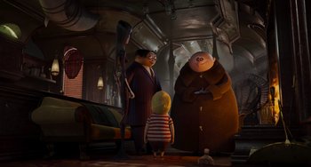 Movie still from “The Addams Family 2” (2021), directed by Greg Tiernan – A group of people standing next to each other in a room; Wide shot, Over the shoulder angle