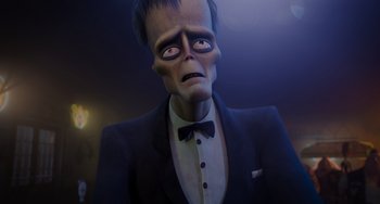 Movie still from “The Addams Family 2” (2021), directed by Greg Tiernan – A man dressed in a suit and tie; Close Up shot, Low angle