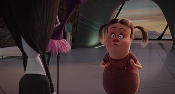 Movie still from “The Addams Family 2” (2021), directed by Greg Tiernan – A woman standing in front of an ostrich in a room; Medium shot, Over the shoulder angle