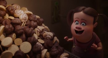 Movie still from “The Addams Family 2” (2021), directed by Greg Tiernan – A large pile of cookies and chocolate chips next to an animated character; Medium shot, Over the shoulder angle
