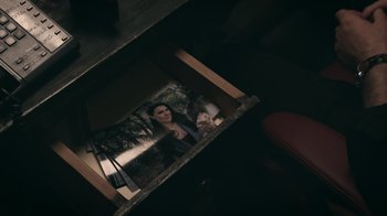 Movie still from “The Amityville Moon” (2021), directed by Thomas J. Churchill – A person is reflected in a mirror in a dark room; Extreme Close Up shot, High angle