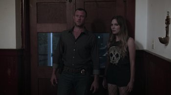 Movie still from “The Amityville Moon” (2021), directed by Thomas J. Churchill – A man and a woman standing next to each other; Medium shot, Over the shoulder angle