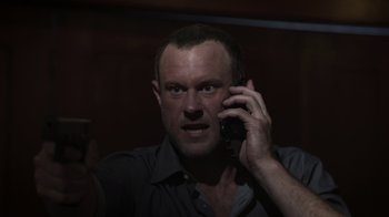 Movie still from “The Amityville Moon” (2021), directed by Thomas J. Churchill – A person talking on a cell phone; Close Up shot, Low angle