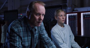 Movie still from “The Avengers” (2012), directed by Joss Whedon – A man and a woman are standing next to each other; Close Up shot, Over the shoulder angle