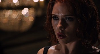 Movie still from “The Avengers” (2012), directed by Joss Whedon – A woman's face in front of lights; Close Up shot, Low angle