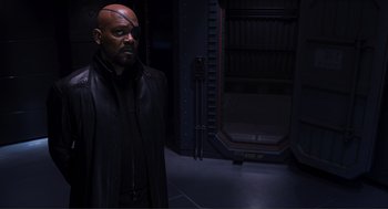 Movie still from “The Avengers” (2012), directed by Joss Whedon – A bald man in a black leather jacket; Medium shot, Over the shoulder angle