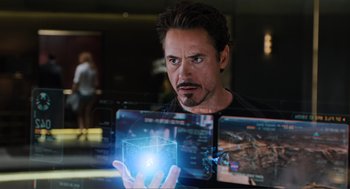 Movie still from “The Avengers” (2012), directed by Joss Whedon – A person holding a cube; Close Up shot, Over the shoulder angle