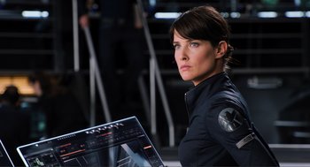 Movie still from “The Avengers” (2012), directed by Joss Whedon – A woman in a black jacket is looking at a computer screen; Close Up shot, Low angle