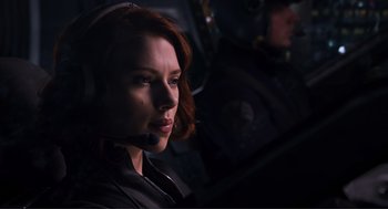 Movie still from “The Avengers” (2012), directed by Joss Whedon – A woman with a headset is looking into the distance; Close Up shot, Low angle