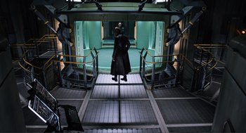 Movie still from “The Avengers” (2012), directed by Joss Whedon – A man standing in front of an entrance to a building; Wide shot, Low angle