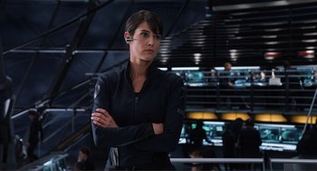 Movie still from “The Avengers” (2012), directed by Joss Whedon – A woman standing in a room with her arms crossed; Close Up shot, Over the shoulder angle