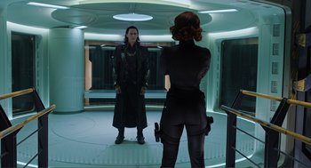 Movie still from “The Avengers” (2012), directed by Joss Whedon – A woman in a black outfit and a man in a black outfit; Medium shot, Over the shoulder angle