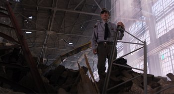 Movie still from “The Avengers” (2012), directed by Joss Whedon – A man standing on top of a pile of rubble; Medium shot, Low angle