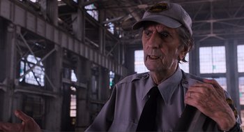 Movie still from “The Avengers” (2012), directed by Joss Whedon – An older man wearing a hat and a uniform; Close Up shot, Over the shoulder angle