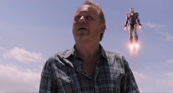Movie still from “The Avengers” (2012), directed by Joss Whedon – A man in a plaid shirt looking up into the sky; Close Up shot, Low angle