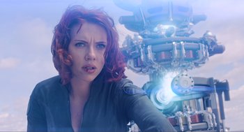 Movie still from “The Avengers” (2012), directed by Joss Whedon – A person with a machine in the background; Medium shot, Over the shoulder angle