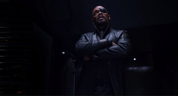 Movie still from “The Avengers” (2012), directed by Joss Whedon – A man wearing a leather jacket and sunglasses; Medium shot, Low angle
