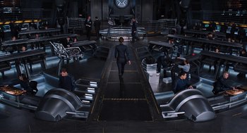 Movie still from “The Avengers” (2012), directed by Joss Whedon – A group of people sitting around a room; Wide shot, High angle