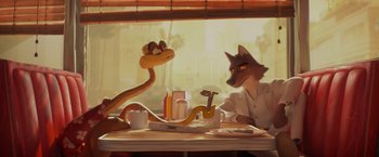 Movie still from “The Bad Guys” (2022), directed by Pierre Perifel – A painting of a dog and a snake sitting at a table; Wide shot, Over the shoulder angle