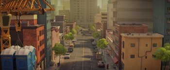 Movie still from “The Bad Guys” (2022), directed by Pierre Perifel – An illustration of a city street with cars parked on the side of the road; Extreme Wide shot, High angle