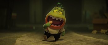 Movie still from “The Bad Guys” (2022), directed by Pierre Perifel – A toy character with an open mouth is holding a piece of food; Medium shot, High angle