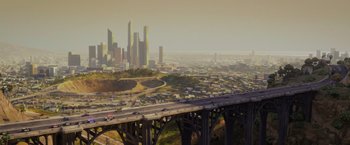 Movie still from “The Bad Guys” (2022), directed by Pierre Perifel – An aerial view of a freeway and a city skyline; Extreme Wide shot, High angle