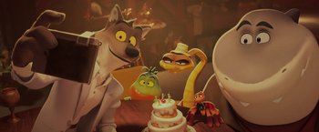 Movie still from “The Bad Guys” (2022), directed by Pierre Perifel – A group of cartoon characters sitting in front of a birthday cake; Medium shot, High angle