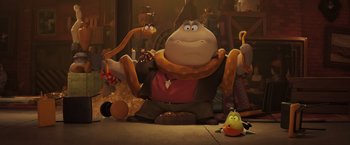 Movie still from “The Bad Guys” (2022), directed by Pierre Perifel – A character sitting in front of a group of other characters; Wide shot, Low angle