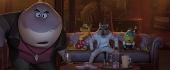 Movie still from “The Bad Guys” (2022), directed by Pierre Perifel – A dog sitting on top of a couch next to another dog; Wide shot, Low angle