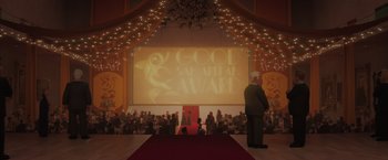 Movie still from “The Bad Guys” (2022), directed by Pierre Perifel – A man standing on a red carpet in front of an audience; Extreme Wide shot, High angle