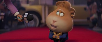 Movie still from “The Bad Guys” (2022), directed by Pierre Perifel – A cartoon character with a microphone; Close Up shot, Over the shoulder angle