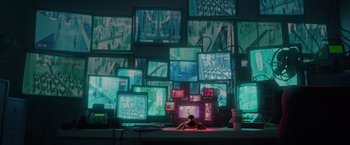 Movie still from “The Bad Guys” (2022), directed by Pierre Perifel – A computer monitor and a person sitting in front of a computer screen; Extreme Wide shot, High angle