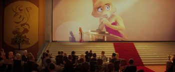 Movie still from “The Bad Guys” (2022), directed by Pierre Perifel – A group of people sitting in front of a projector screen; Wide shot, Over the shoulder angle