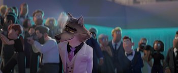 Movie still from “The Bad Guys” (2022), directed by Pierre Perifel – A wolf wearing a suit and tie in front of a group of people; Medium shot, Over the shoulder angle