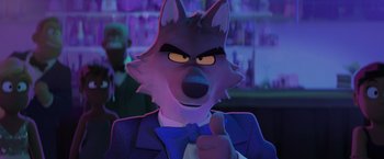 Movie still from “The Bad Guys” (2022), directed by Pierre Perifel – A cartoon wolf wearing a suit and tie giving a thumbs up; Medium shot, Over the shoulder angle