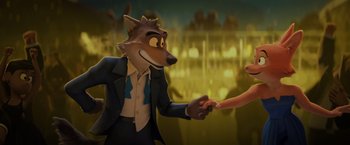 Movie still from “The Bad Guys” (2022), directed by Pierre Perifel – A man and a woman shaking hands in front of a crowd; Medium shot, Over the shoulder angle