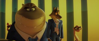 Movie still from “The Bad Guys” (2022), directed by Pierre Perifel – Two cartoon characters in a suit and tie standing next to each other in front of a striped wall; Medium shot, Low angle