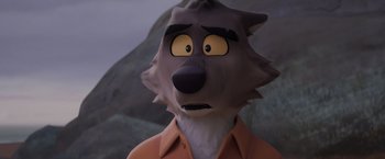 Movie still from “The Bad Guys” (2022), directed by Pierre Perifel – A man wearing a wolf mask with a mountain in the background; Close Up shot, High angle
