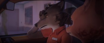 Movie still from “The Bad Guys” (2022), directed by Pierre Perifel – A stuffed animal wolf wearing an orange jacket; Close Up shot, Over the shoulder angle