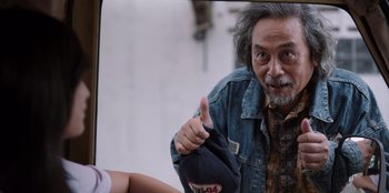 Movie still from “The Big 4” (2022), directed by Timo Tjahjanto – An older man giving a thumbs up in front of a mirror; Medium shot, Low angle