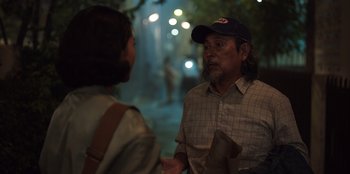 Movie still from “The Big 4” (2022), directed by Timo Tjahjanto – A man and a woman are talking on the street; Medium shot, Over the shoulder angle