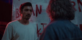 Movie still from “The Big 4” (2022), directed by Timo Tjahjanto – A man standing in front of a mirror looking at himself in the mirror; Close Up shot, Over the shoulder angle